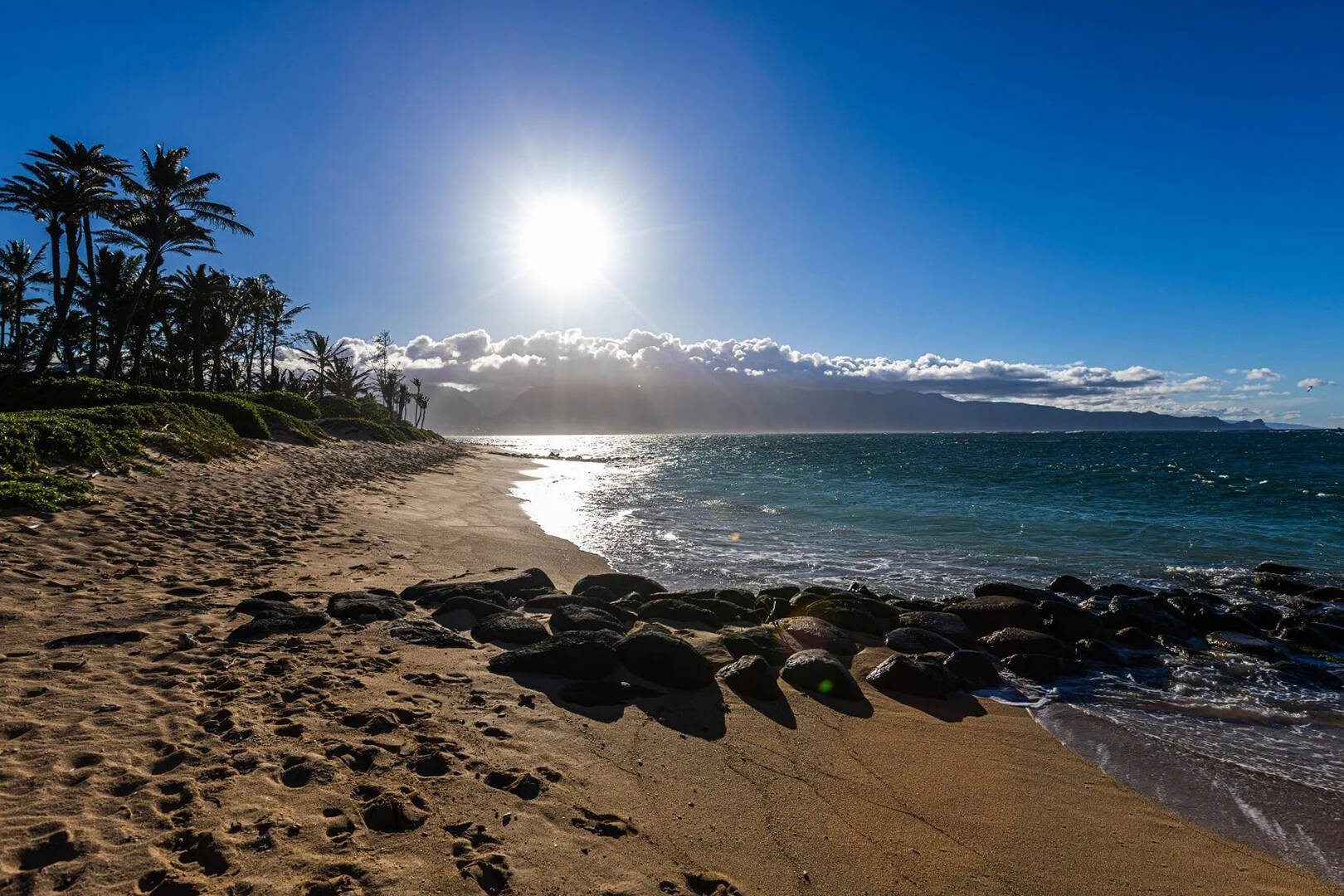 A view of an ocean with a rocky breakwater structure