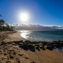 A view of an ocean with a rocky breakwater structure