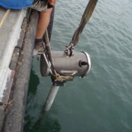 Equipment used for dredging submerged in Hilo Harbor waters