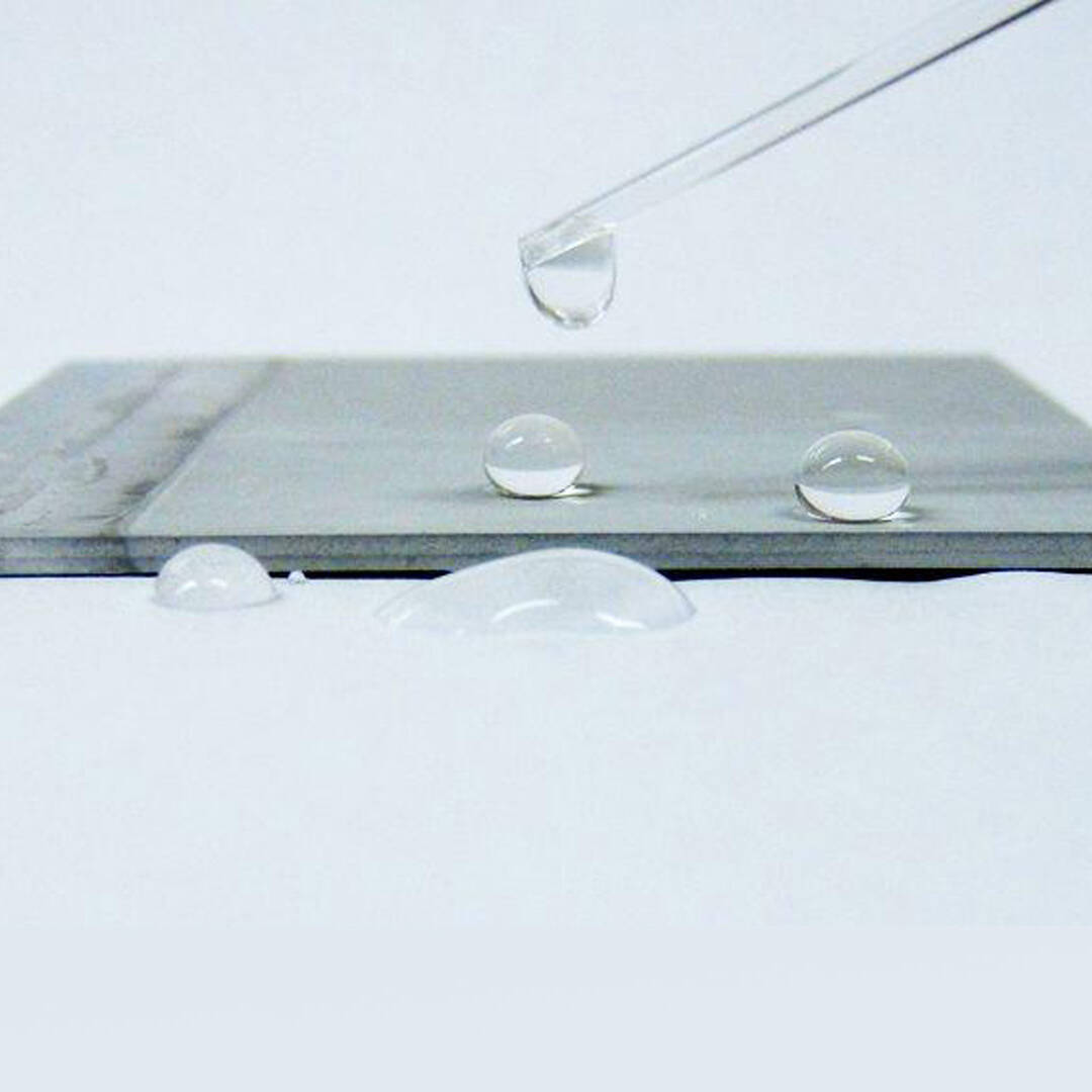 A metal surface with water droplets on the surface
