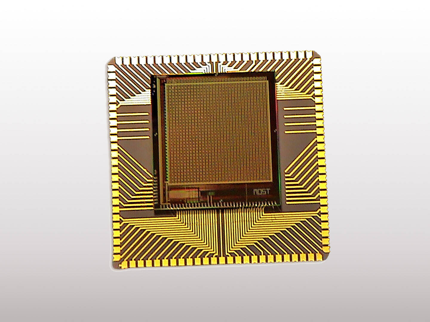 A gold colored computer chip on a white background