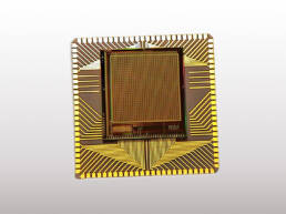 A gold colored computer chip on a white background