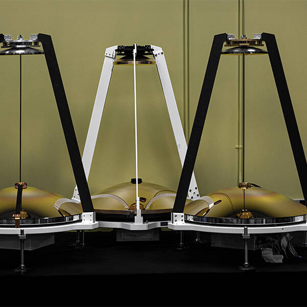 Three MAMBA atmospheric sensors lined up in a room