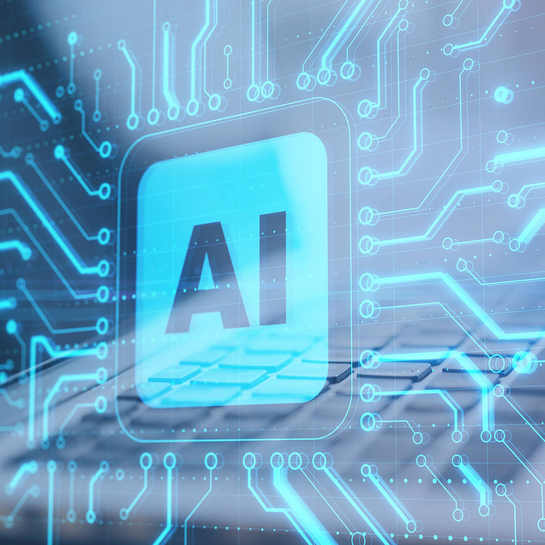 A 3D render of a blue computer chip with AI printed in the middle