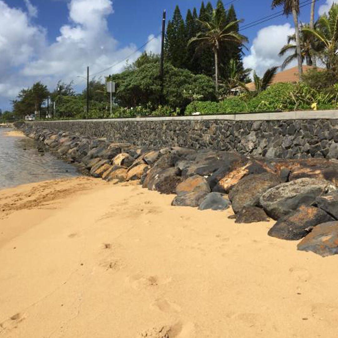A seawall stretching along a coastline in Kauai