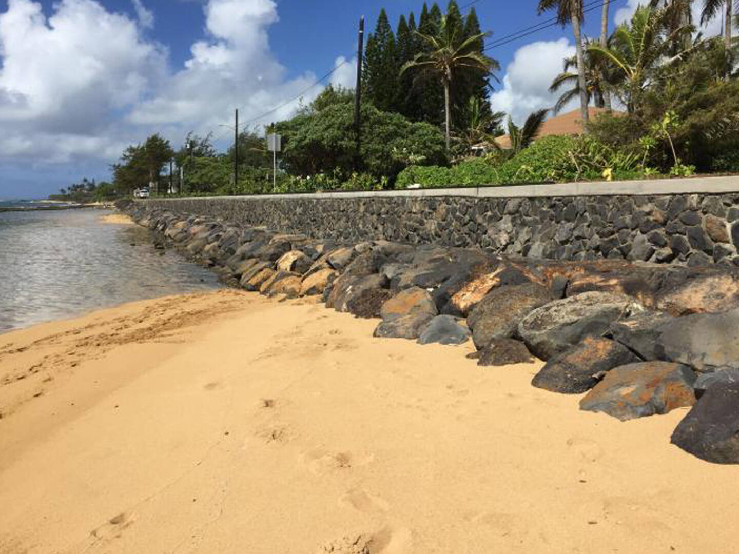 A seawall stretching along a coastline in Kauai