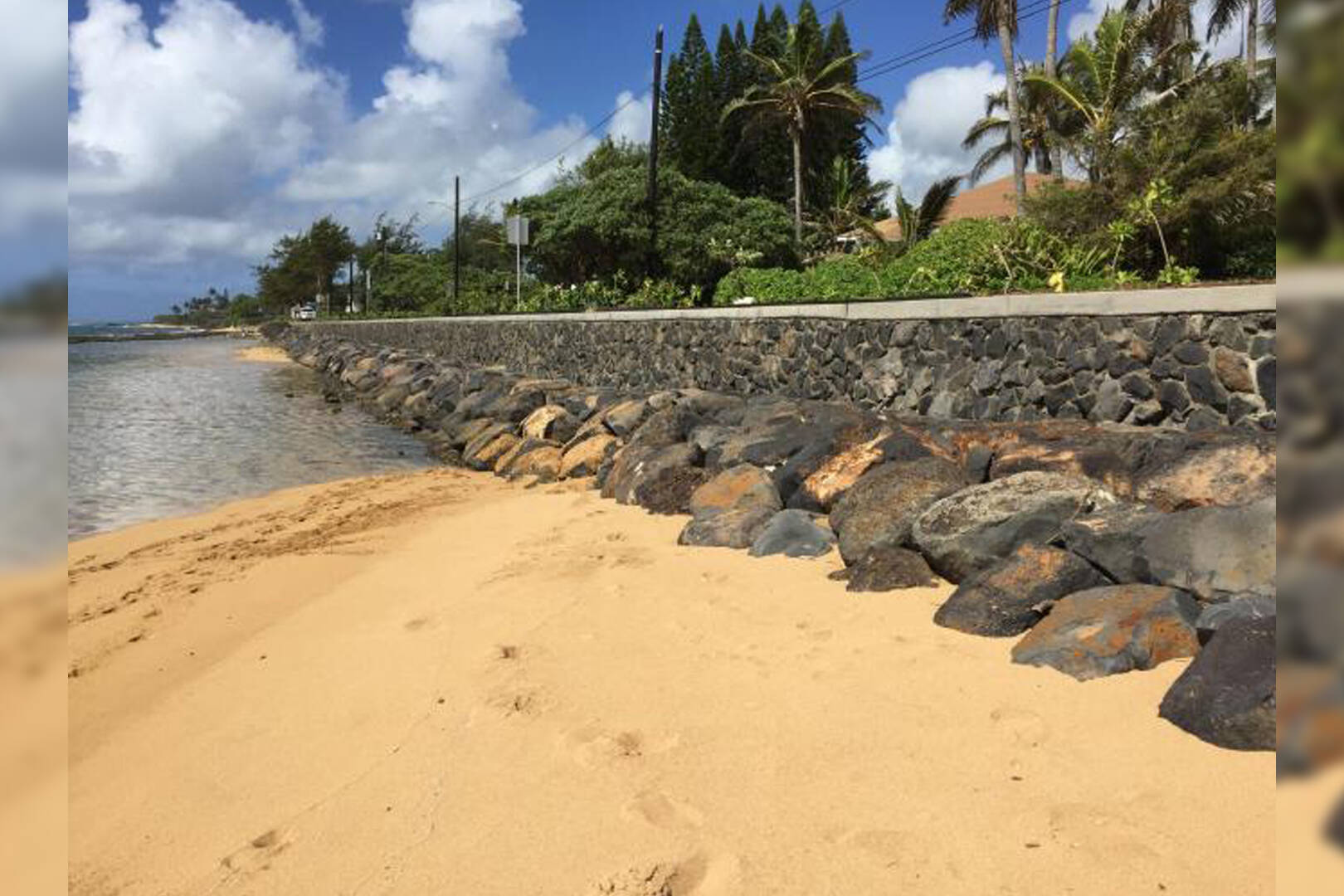A seawall stretching along a coastline in Kauai