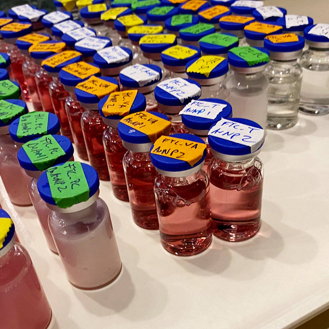 A tray filled with vials with colorful liquid inside