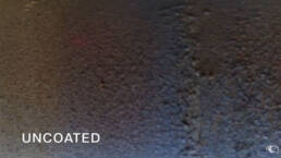 An uncoated metal surface, pitted and with debris