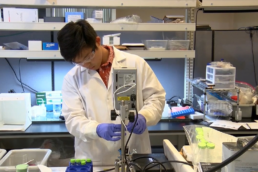 A student intern using machinery in the oceanit lab