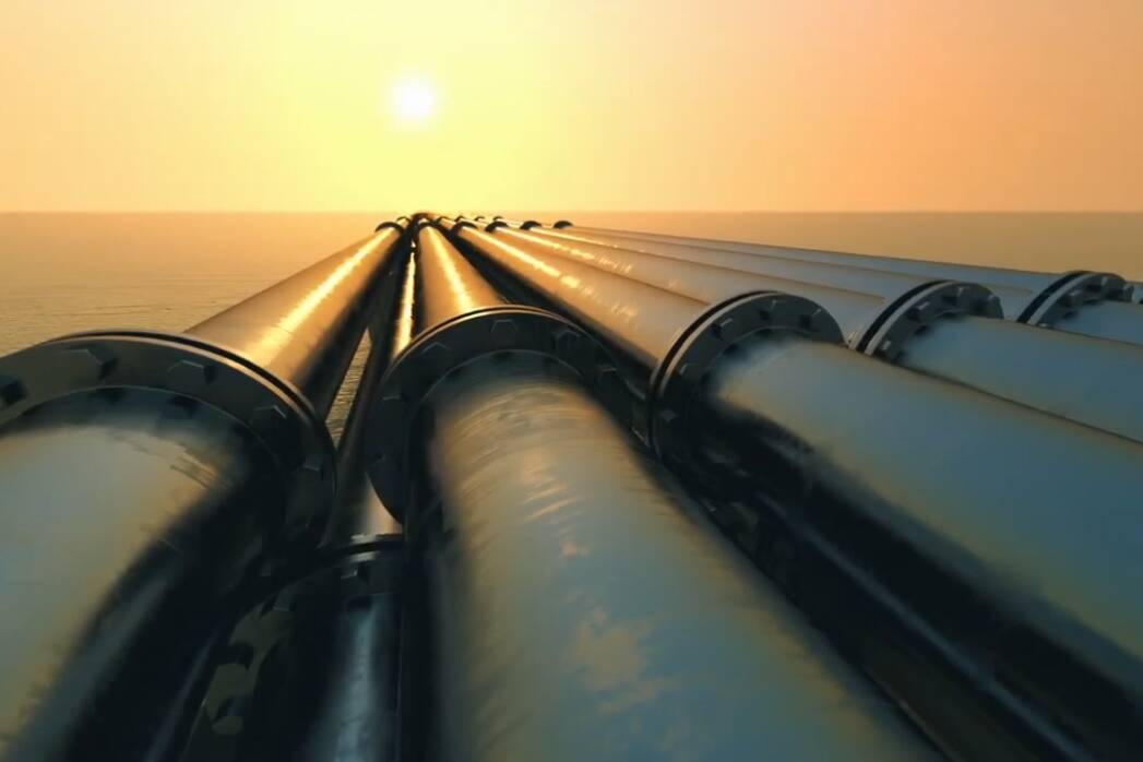 Pipelines leading to the horizon, where the sun sets over the ocean