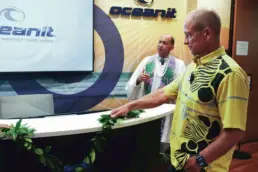Patrick Sullivan placing a lei on the Oceanit front desk