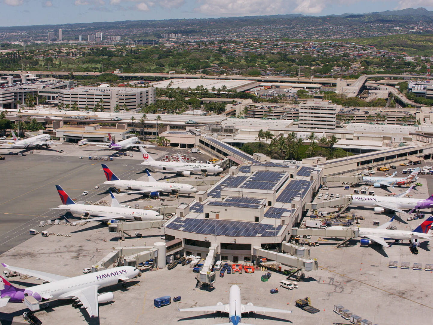 An aerial shot of an HNL terminal with planes parked at the gates