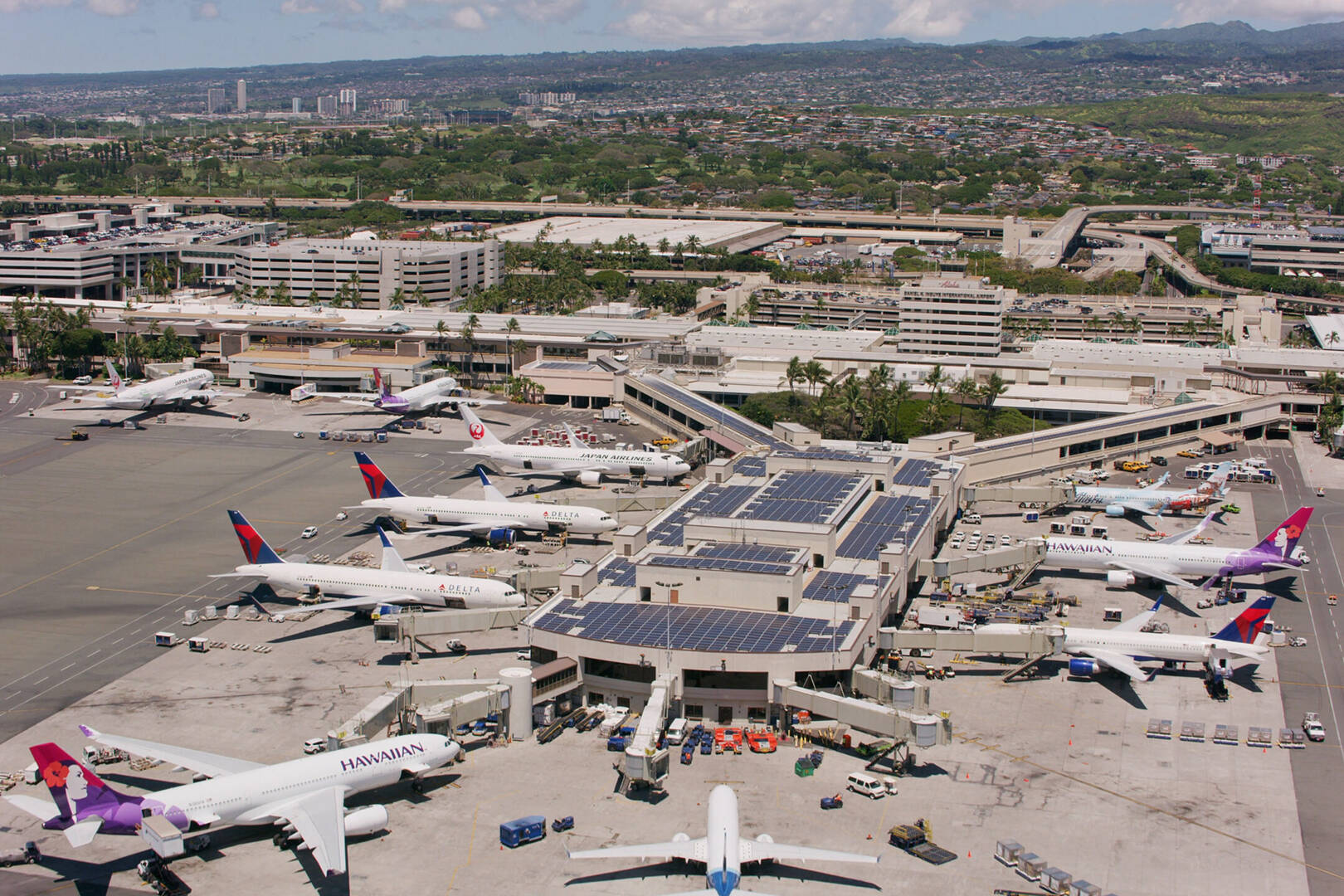 An aerial shot of an HNL terminal with planes parked at the gates