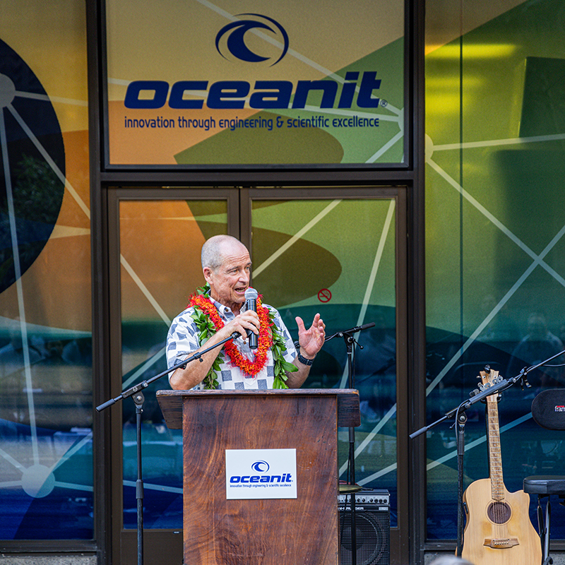 Pat Sullivan speaking at a podium outside the Oceanit headquarters