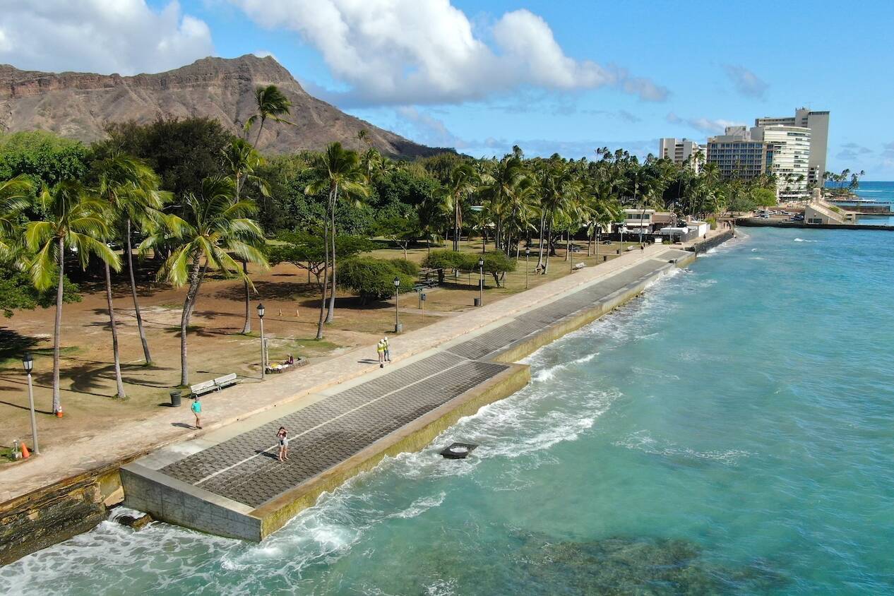 The Queens Beach Waikiki shoreline with an installed seawall and Diamond Head in the background