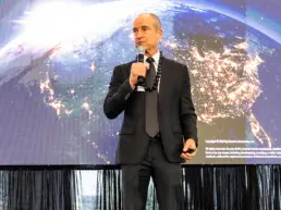 Patrick Sullivan on stage in front of a slide which reads Oceanit Technology Showcase