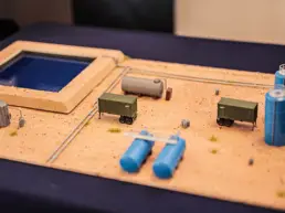 A miniature diorama showing the layout of containers and pipelines