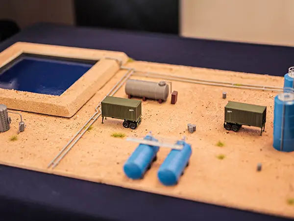 A miniature diorama showing the layout of containers and pipelines