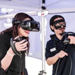 A man and a woman piloting a VR drone