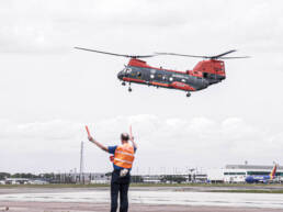A Marines C-47 Chinook helicopter taking off from an airport tarmac