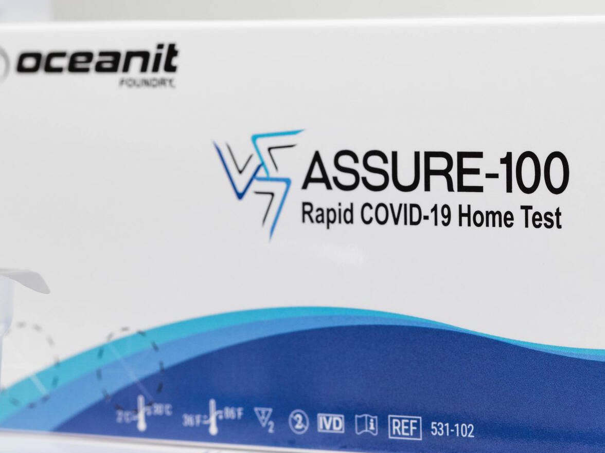 A white and blue box containing Oceanit's ASSURE-100 Rapid COVID-19 Home Test