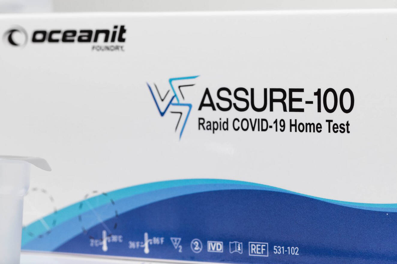 A white and blue box containing Oceanit's ASSURE-100 Rapid COVID-19 Home Test