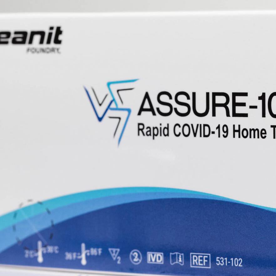 A white and blue box containing Oceanit's ASSURE-100 Rapid COVID-19 Home Test