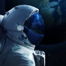 An astronaut wearing a space suit in profile