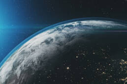 Earth and its atmosphere, with the sun in the background