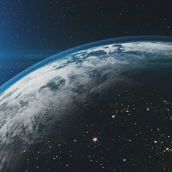 Earth and its atmosphere, with the sun in the background