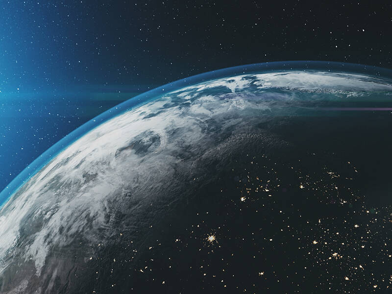 Earth and its atmosphere, with the sun in the background