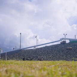 A pipeline elevated above the earth on rocky terrain