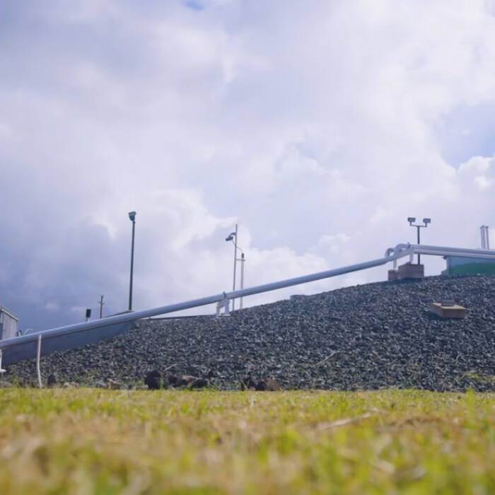 A pipeline elevated above the earth on rocky terrain