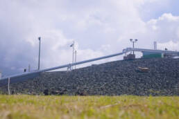 A pipeline elevated above the earth on rocky terrain