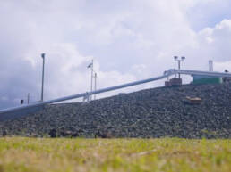 A pipeline elevated above the earth on rocky terrain