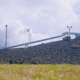 A pipeline elevated above the earth on rocky terrain