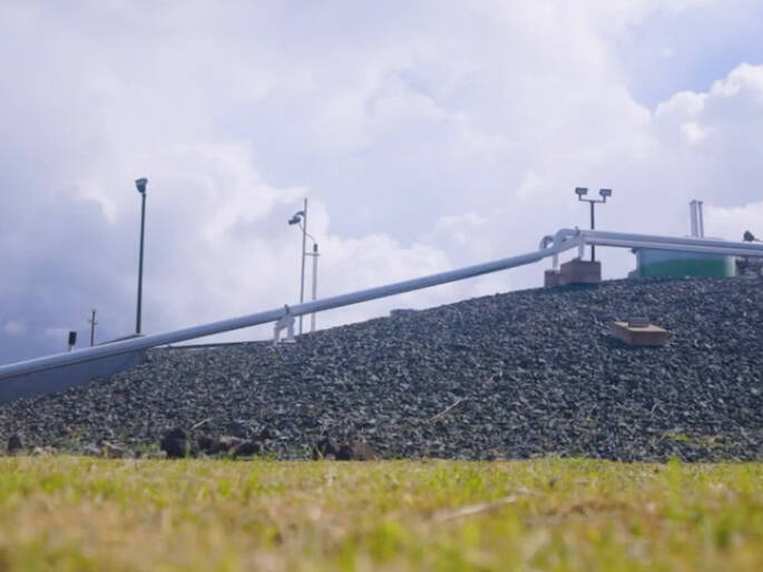 A pipeline elevated above the earth on rocky terrain