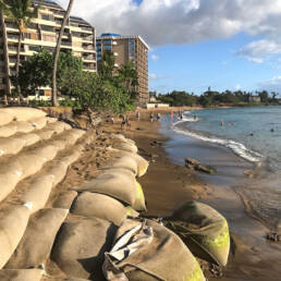 Large sandbags on the Kahana Bay shoreline