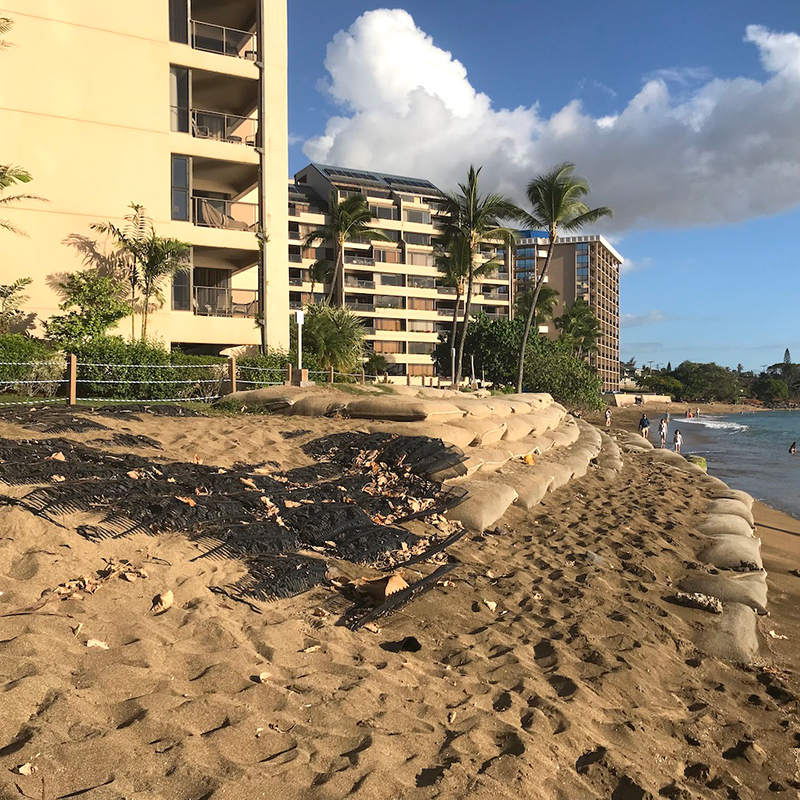 Layers of sandbags on the Kahana Bay shoreline