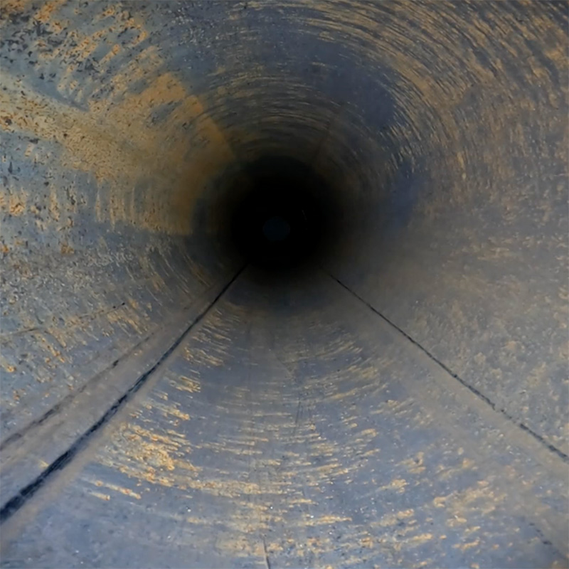 The inside of a pipeline, with debris and wear visible