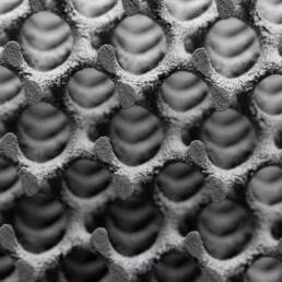 A close up of a gyroid structure, a complex, lightweight 3D shape