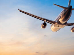 A plan flying away from the camera into a sunset