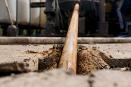 A large cable being inserted horizontally underground