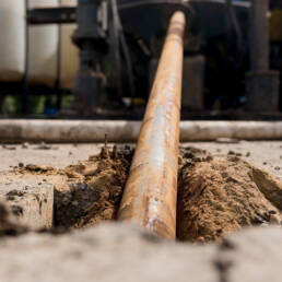 A large cable being inserted horizontally underground