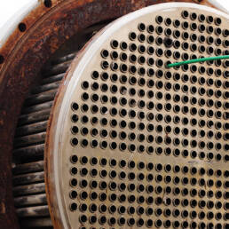 A rod sticking out of one of many holes in a heat exchanger front