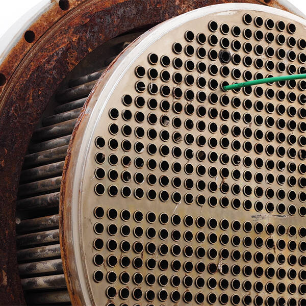 A rod sticking out of one of many holes in a heat exchanger front
