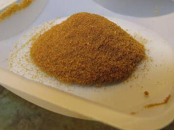 A tray of DERT powder in a pile on a white tray