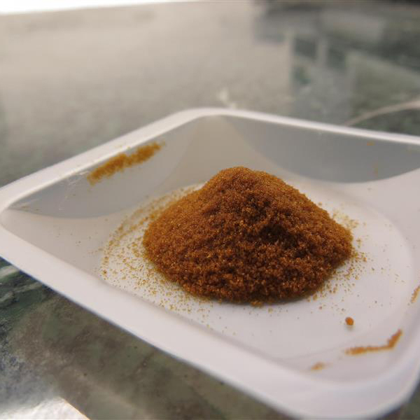 A tray of DERT powder in a pile on a white tray
