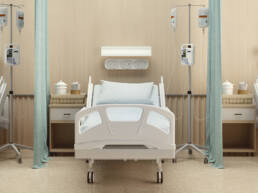 A hospital room with three symmetrical hospital beds and curtains separating them